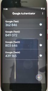 Google Authenticator app on a phone with 2FA codes.