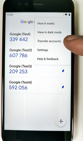 An image of a mobile phone with Transfer Accounts option in the app menu.