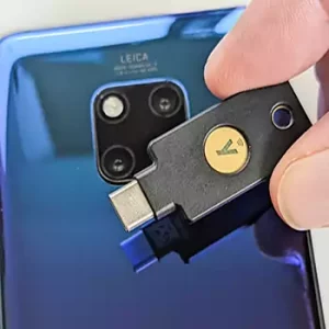 Tapping the back of the phone with a YubiKey 5C NFC.
