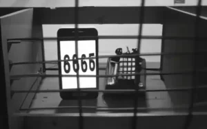 A mobile phone in the box with numbers on the screen.